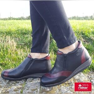 Rieker 44273 black and burgundy leather ankle boots with a zipper closure.